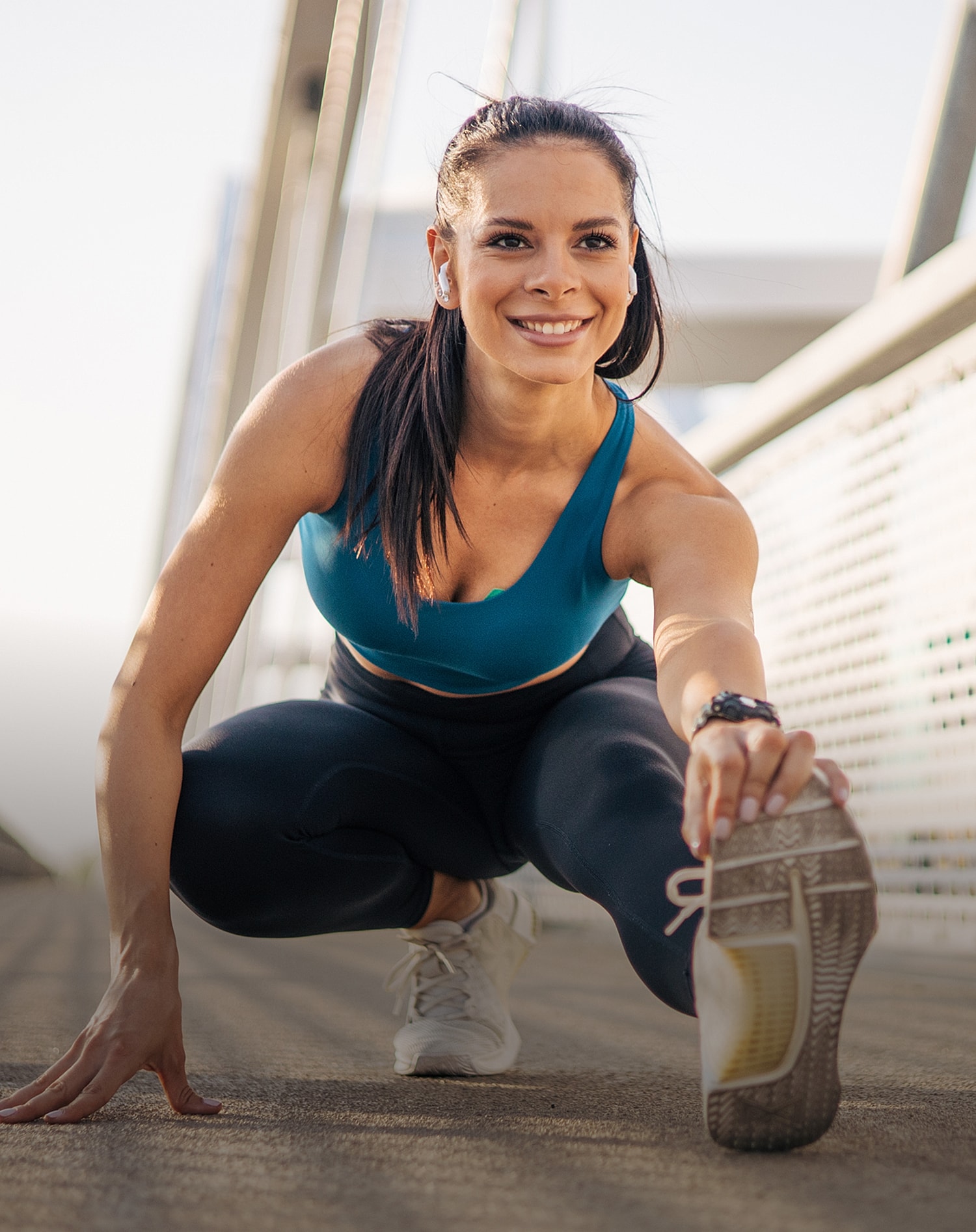 Lancaster orthopedic surgery woman stretching on outdoor bridge pathway.