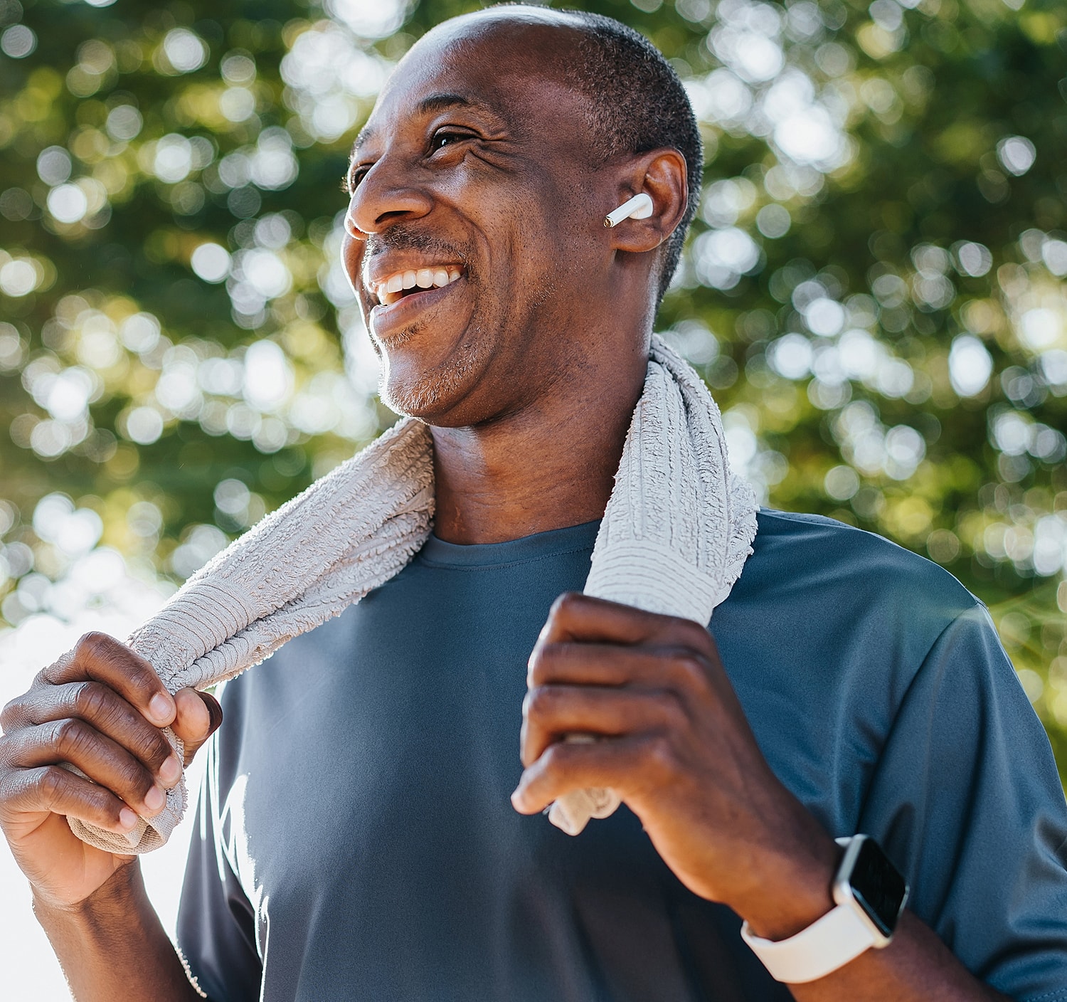 Smiling Lancaster orthopedic surgery man in workout attire with towel.